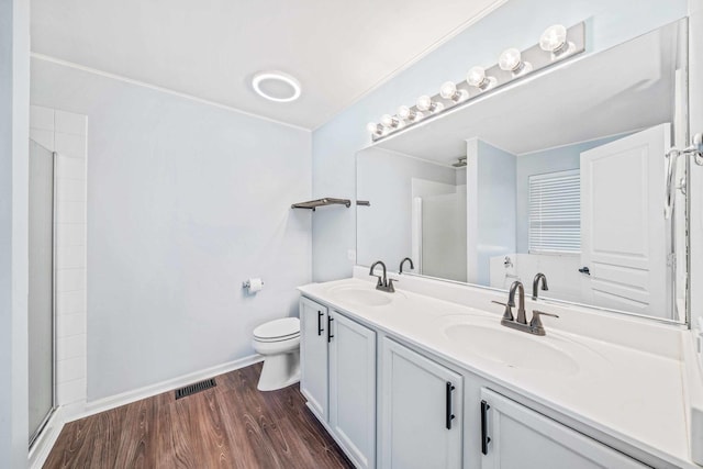 bathroom with vanity, hardwood / wood-style flooring, toilet, and walk in shower