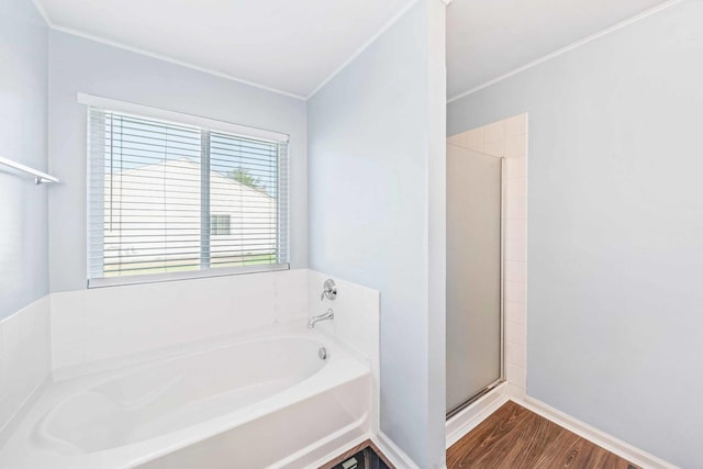 bathroom featuring hardwood / wood-style floors and separate shower and tub