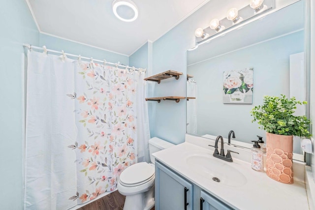 bathroom featuring hardwood / wood-style flooring, vanity, toilet, and curtained shower