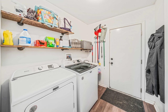 clothes washing area with dark hardwood / wood-style flooring and washing machine and dryer