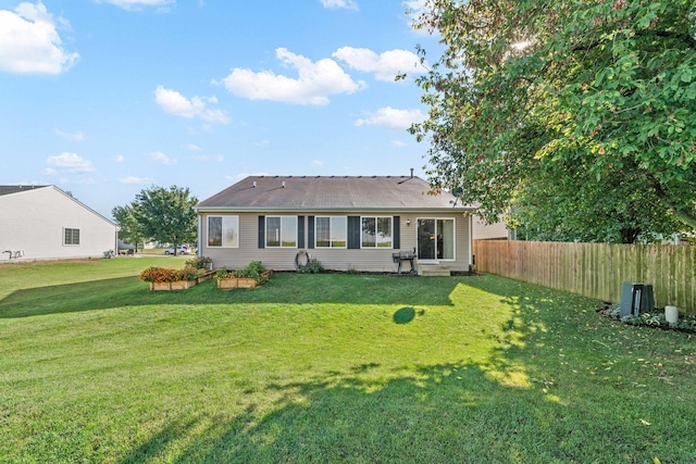 rear view of property with a lawn