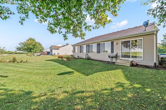 rear view of property with a lawn