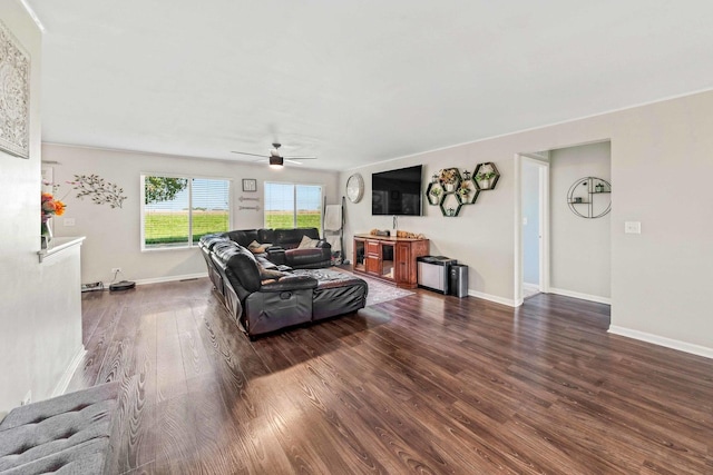 living room featuring dark hardwood / wood-style flooring and ceiling fan