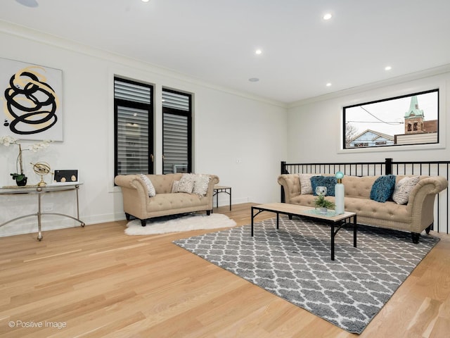 living room with hardwood / wood-style floors and crown molding