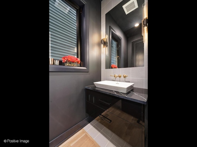 bathroom featuring tasteful backsplash, vanity, and tile patterned floors