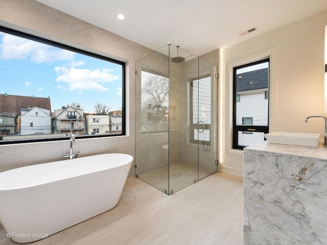 bathroom with sink and independent shower and bath