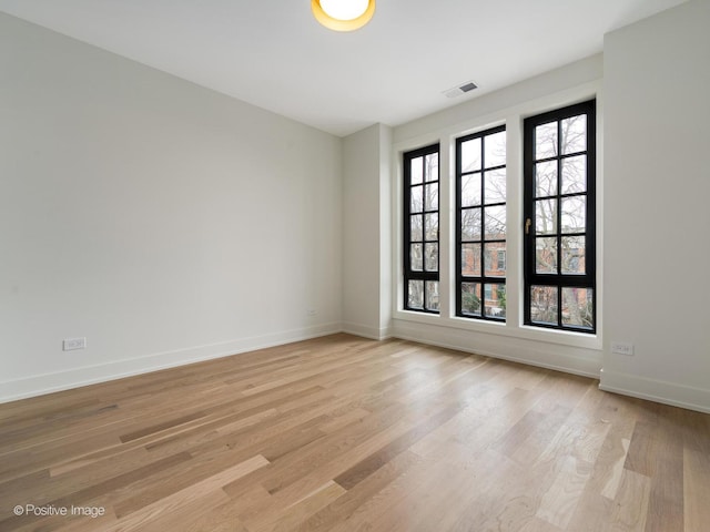 unfurnished room featuring light hardwood / wood-style floors