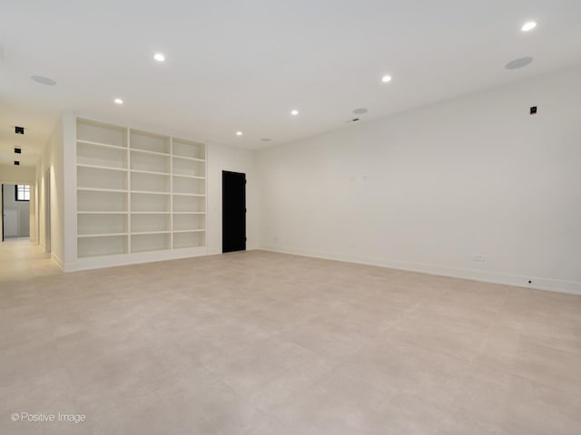 unfurnished room with built in shelves