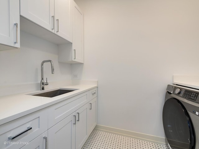 washroom with cabinets, washer / dryer, and sink