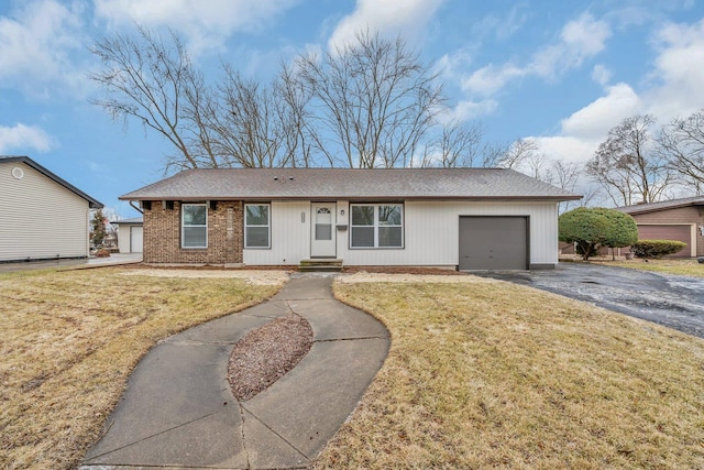 ranch-style home with a garage and a front lawn