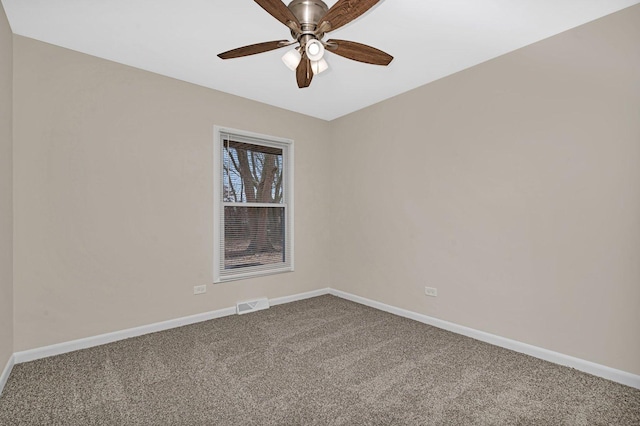 spare room featuring carpet floors and ceiling fan