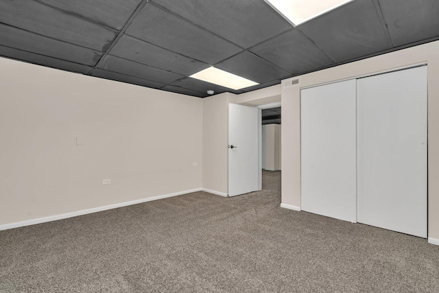 basement with carpet floors and a paneled ceiling