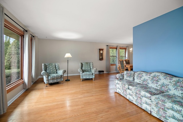 living room with light wood-type flooring and baseboards