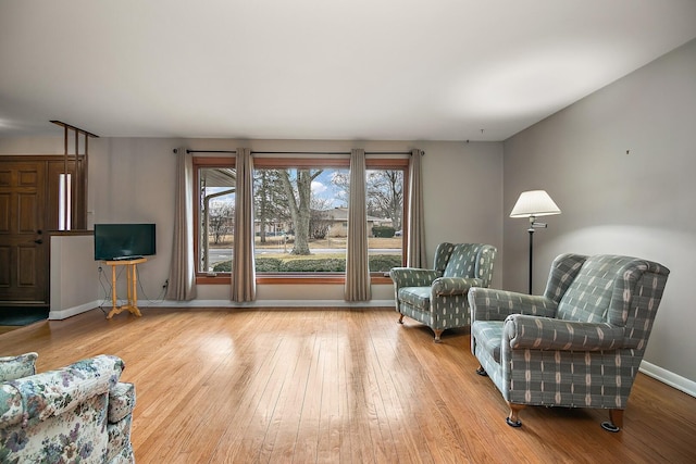 sitting room featuring baseboards and wood finished floors