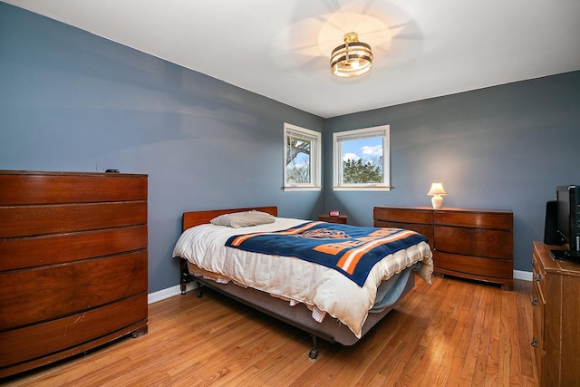 bedroom featuring light wood-style flooring and baseboards