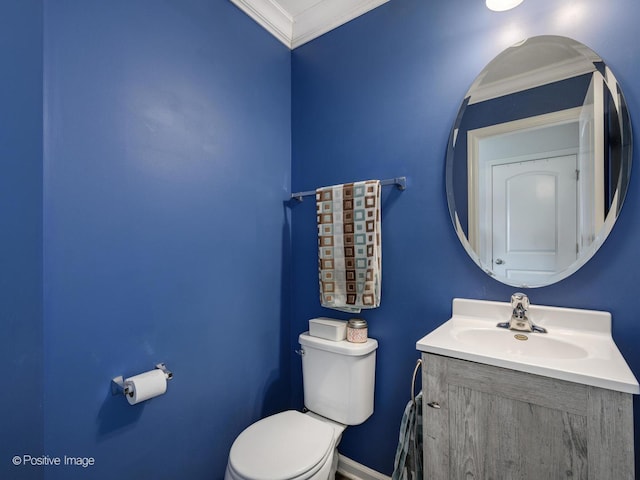 bathroom featuring crown molding, vanity, and toilet