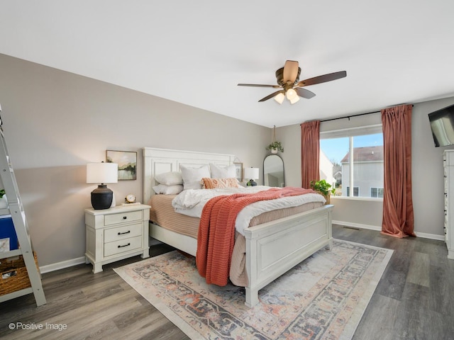 bedroom with dark hardwood / wood-style flooring and ceiling fan