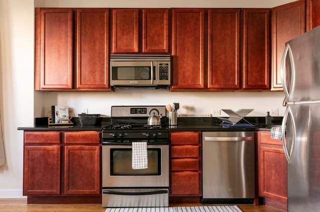 kitchen featuring hardwood / wood-style flooring and stainless steel appliances