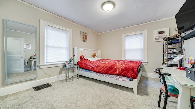 bedroom featuring crown molding and carpet flooring