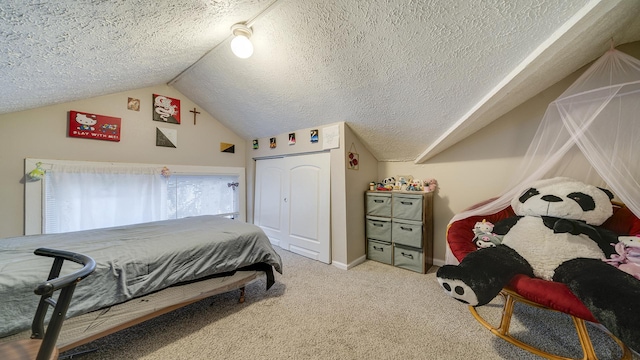 bedroom with a closet, carpet floors, vaulted ceiling, and a textured ceiling