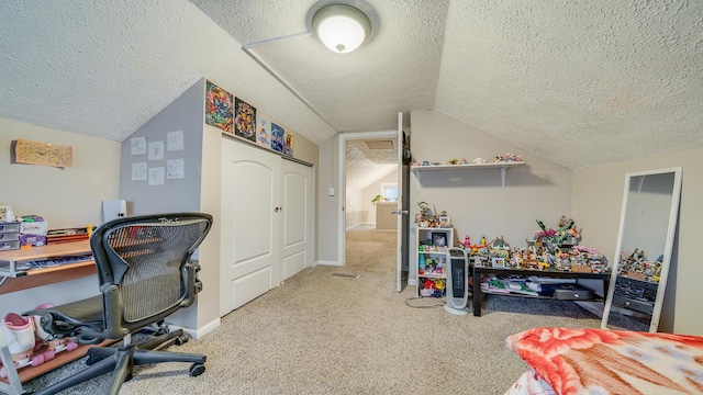 home office with lofted ceiling, carpet floors, and a textured ceiling