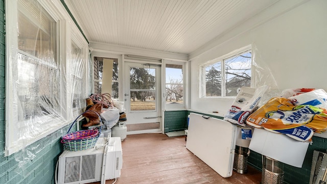 sunroom / solarium with a wall unit AC and wooden ceiling