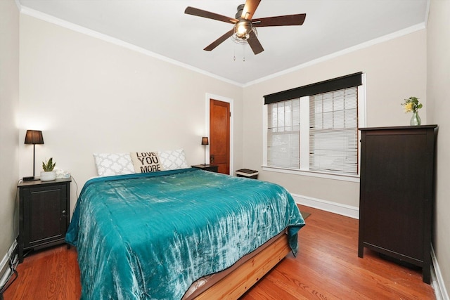 bedroom featuring ornamental molding, hardwood / wood-style floors, and ceiling fan