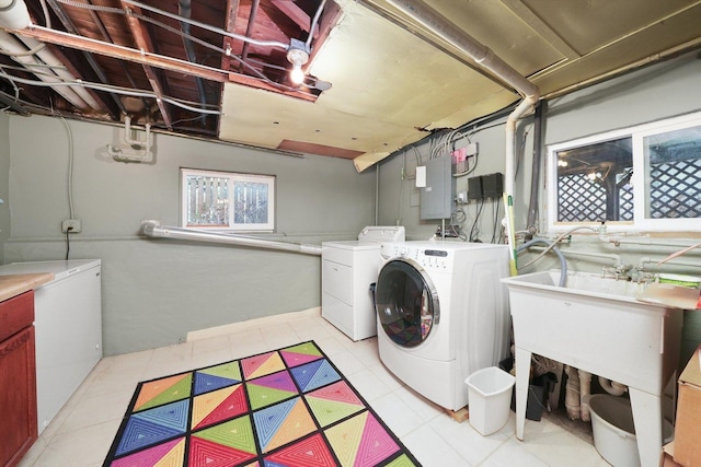 laundry area with light tile patterned flooring, independent washer and dryer, and electric panel