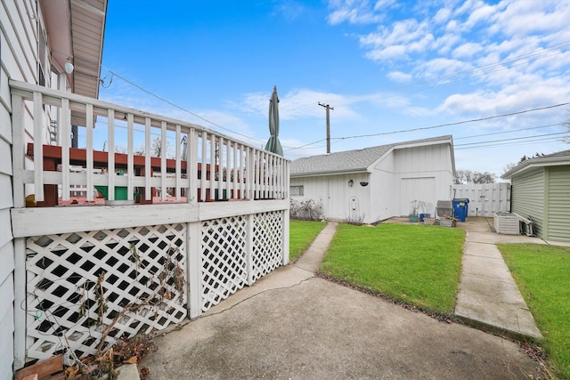 view of side of property with a yard and a deck