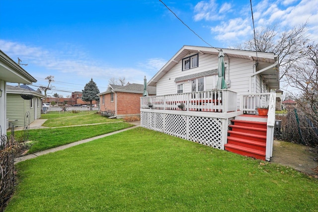 back of property featuring a lawn and a deck