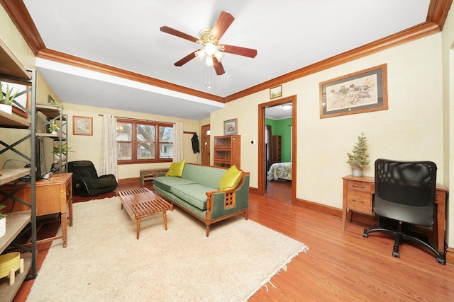 living room featuring ornamental molding, ceiling fan, and light hardwood / wood-style flooring