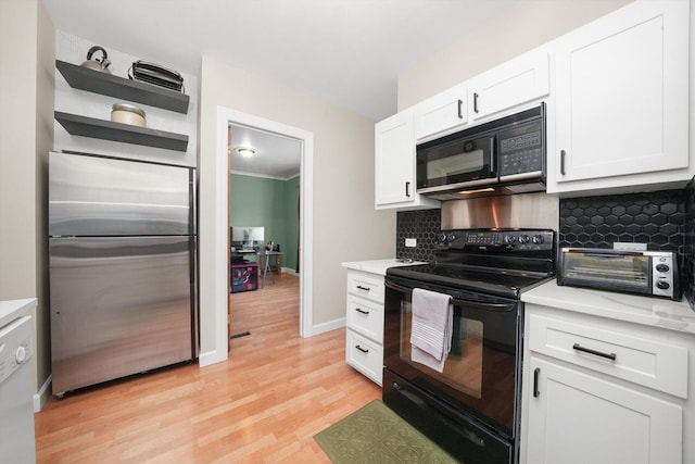 kitchen with tasteful backsplash, white cabinets, light wood-type flooring, and black appliances