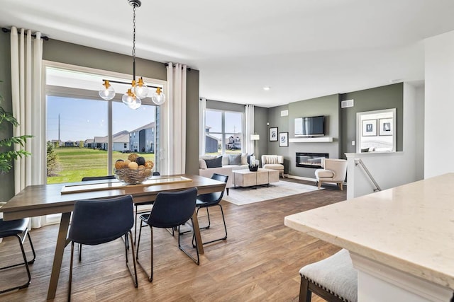 dining room with hardwood / wood-style floors and an inviting chandelier