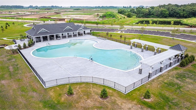 view of pool with a pergola and a rural view