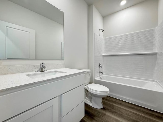 full bathroom with vanity, hardwood / wood-style floors, shower / bathtub combination, and toilet