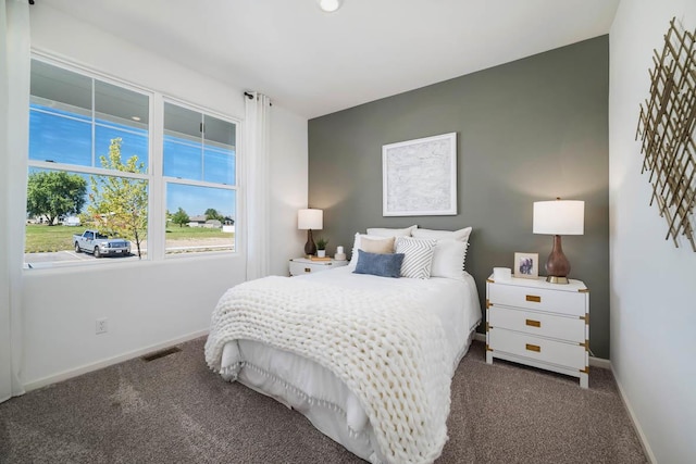 bedroom featuring dark carpet