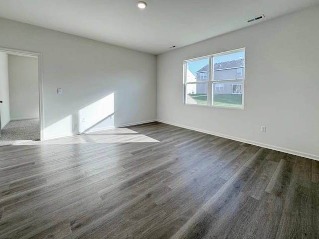 spare room with dark hardwood / wood-style floors