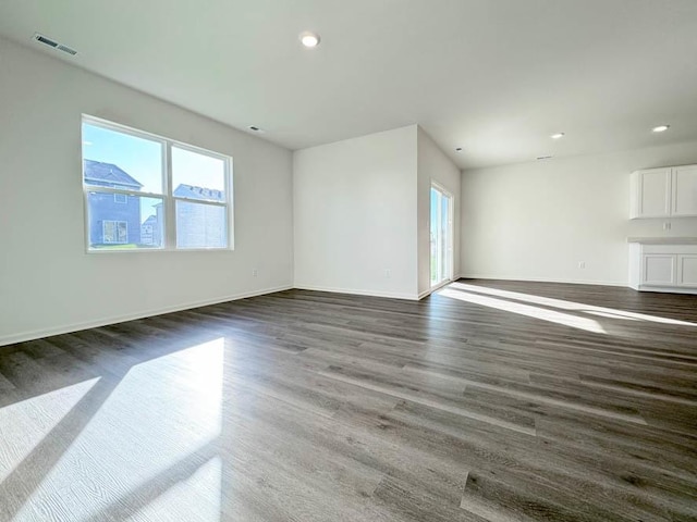 unfurnished living room with dark hardwood / wood-style flooring