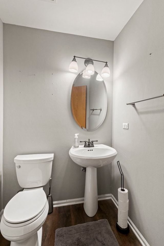 bathroom with wood-type flooring and toilet