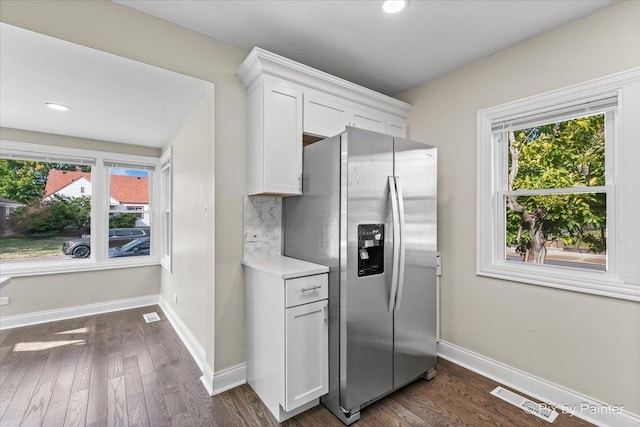 kitchen featuring decorative backsplash, dark hardwood / wood-style floors, white cabinets, and stainless steel fridge with ice dispenser