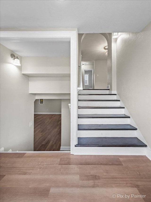 stairway with hardwood / wood-style flooring