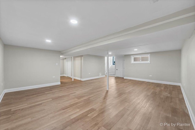 basement with light hardwood / wood-style floors