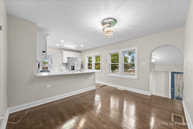 unfurnished living room featuring dark wood-type flooring