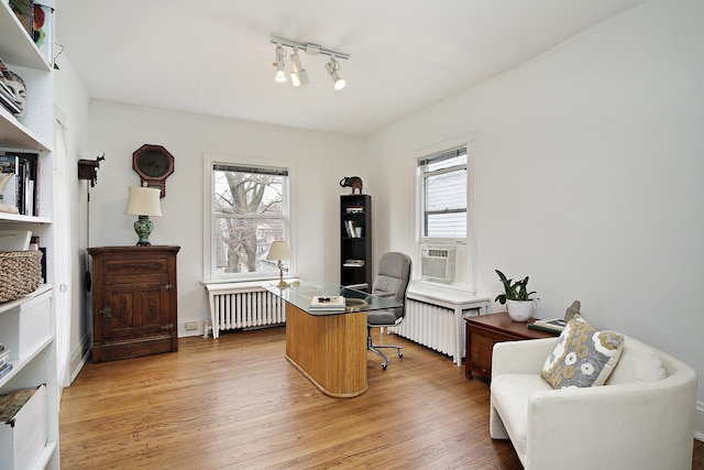 home office featuring radiator heating unit and light wood-type flooring