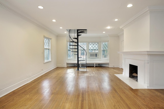 unfurnished living room featuring crown molding, light hardwood / wood-style floors, and a wealth of natural light