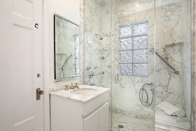 bathroom featuring vanity and a shower with shower door