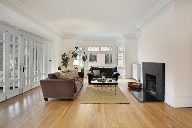 living room with ornamental molding and light wood-type flooring