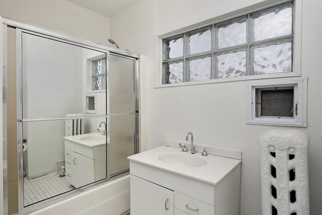 bathroom featuring vanity and combined bath / shower with glass door