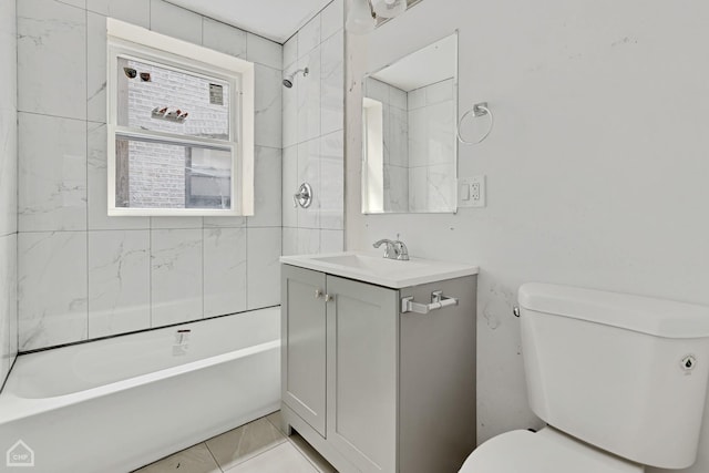 full bathroom featuring vanity, tiled shower / bath combo, and toilet