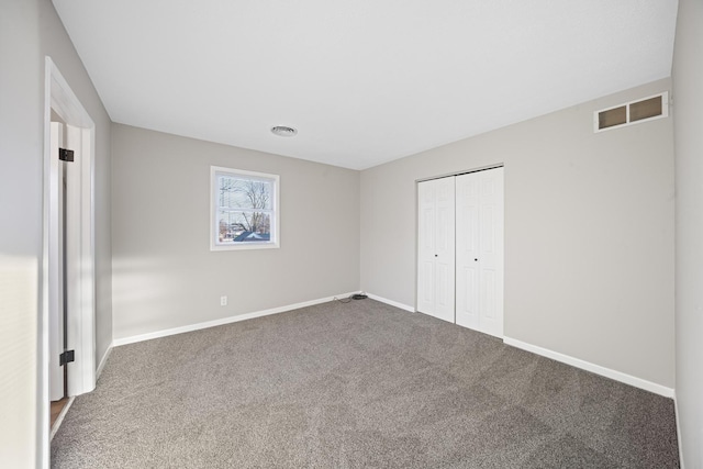 unfurnished bedroom with carpet and a closet